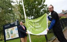 Councillor Damien Greenhalgh and Tref Jones from AES raise this year's flag