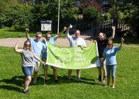 Councillor Damien Greenhalgh with staff and volunteers and this year's Green Flag